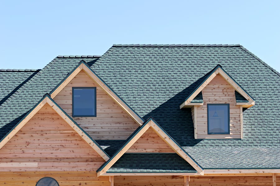 roofing architecture of a brand new home, closeup with blue sky Shingles and Modified Rubber Roofing