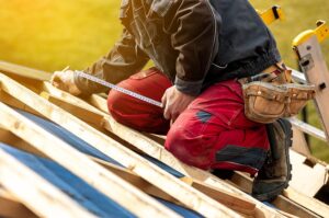 Roofer replacing the wood on the roof